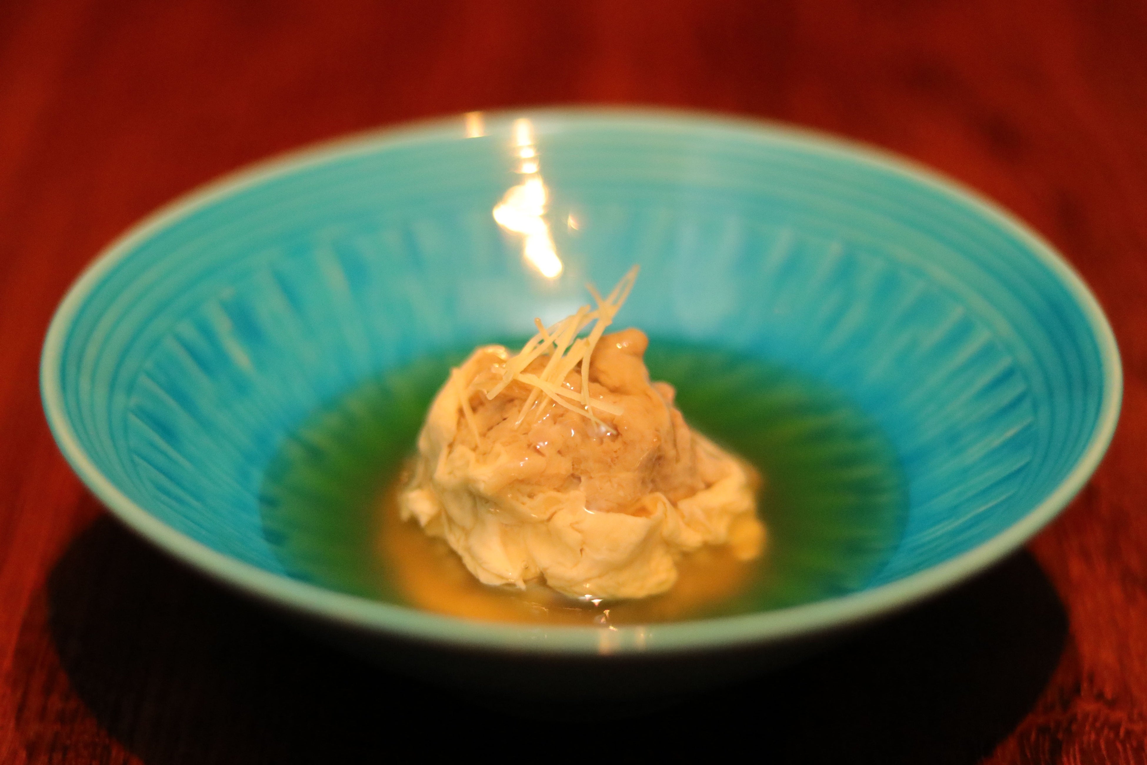 鴨の湯葉真薯：鴨のふんわりとした真薯（しんじょ）と湯葉に、マグロ節の銀餡をかけたお出汁がやさしく香る一品。