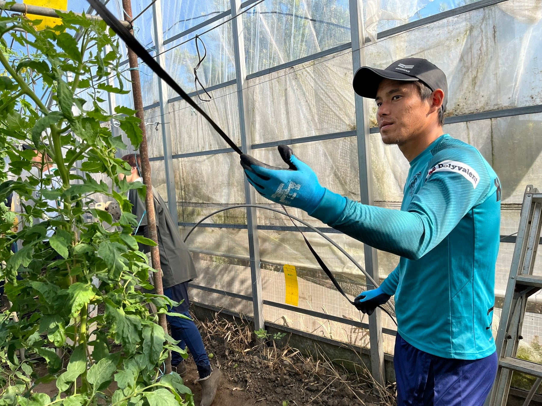 生産者の現場で農作業の手伝いをしている風景 ※ヴェロスクロノス都農（宮崎県都農町）所属選手