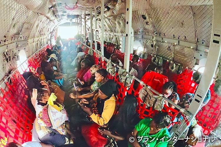 輸送機で他国に逃れる人々