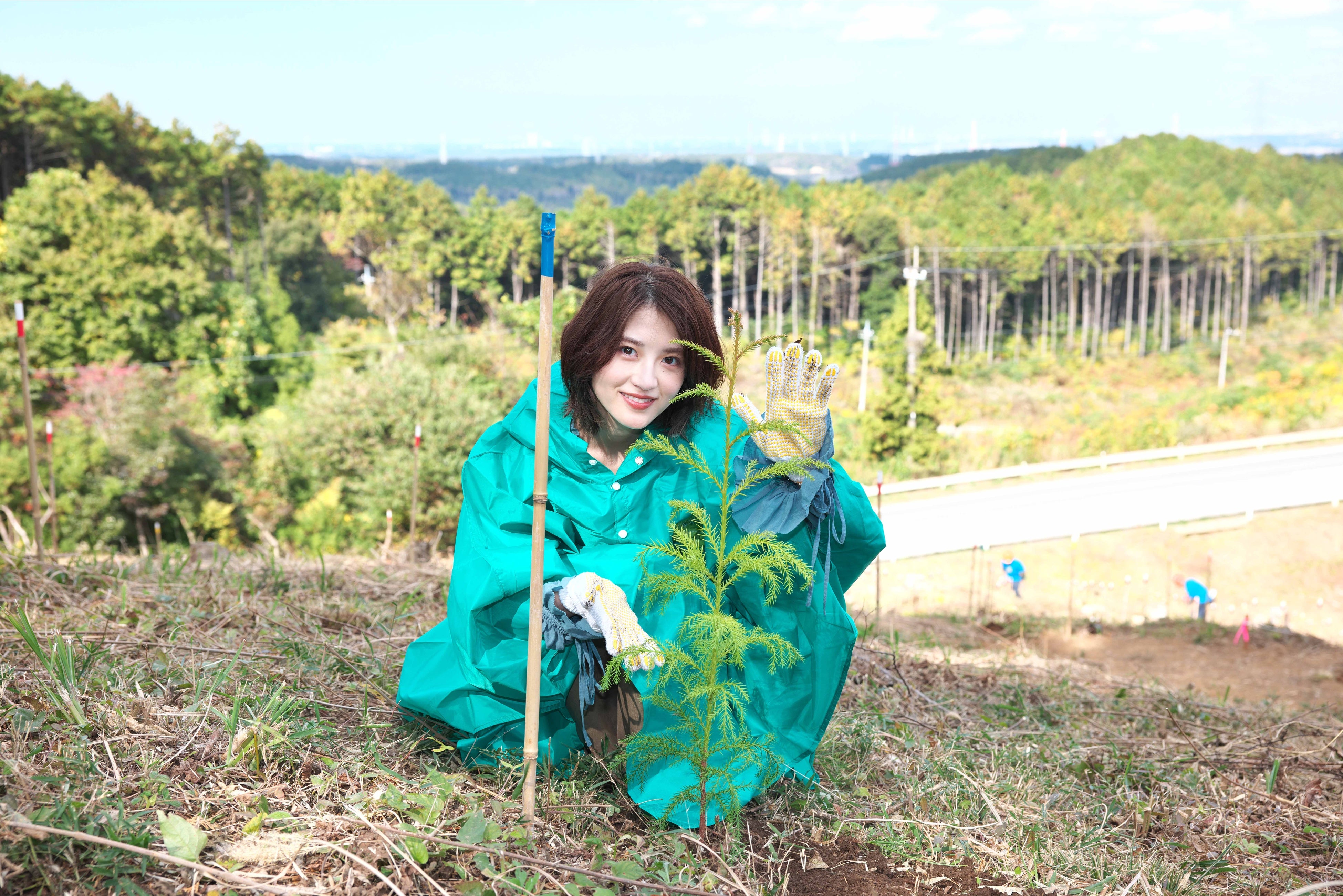 ▲植樹を体験した若月佑美。初めて植えた苗木と。