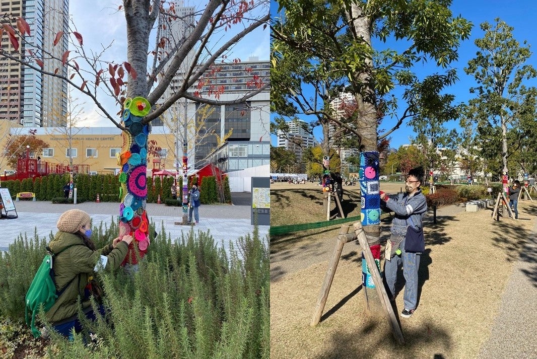 IKE・SUNPARK内樹木に編みモチーフを巻きつける作業