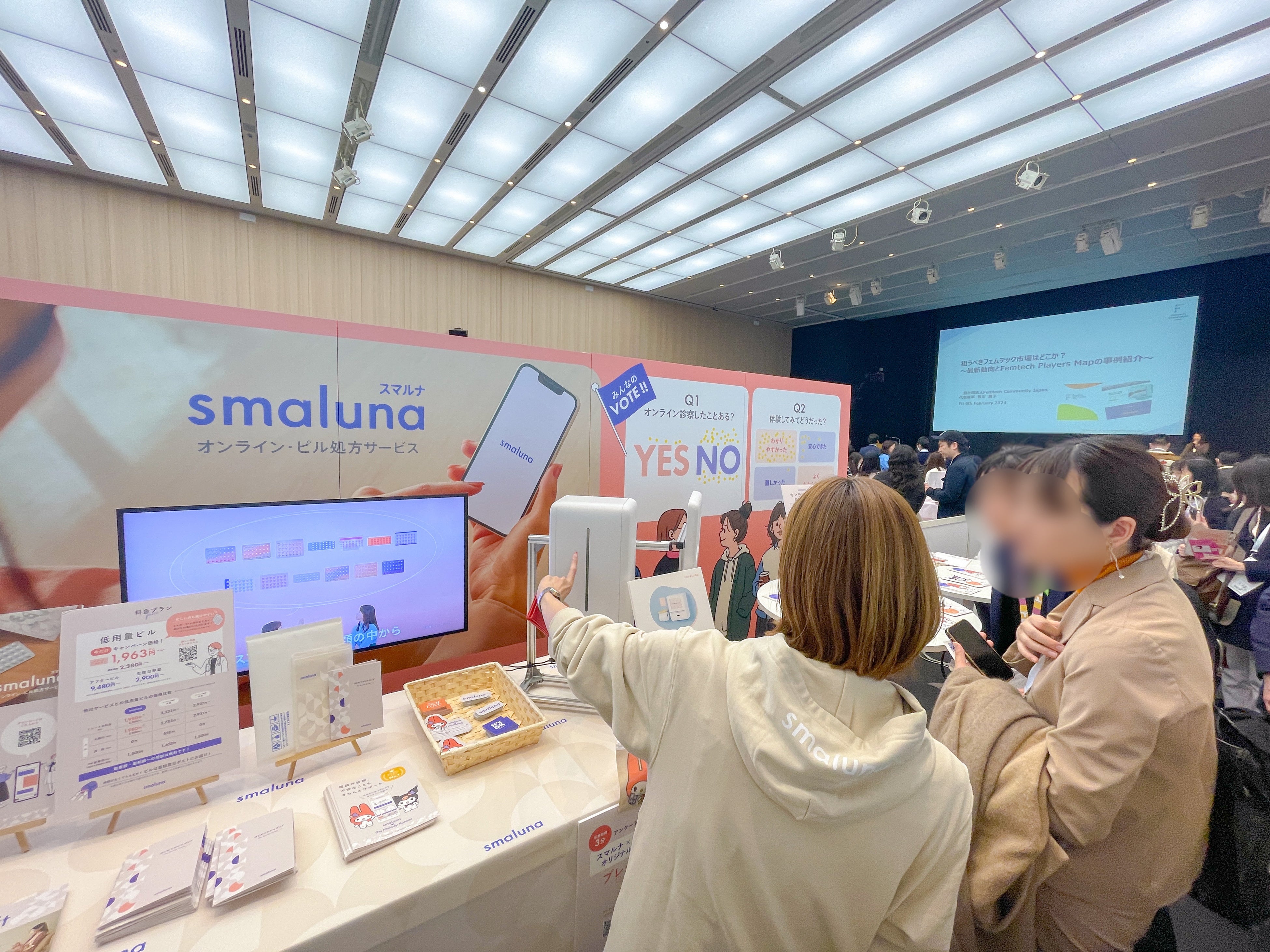 （来場者にスマルナのサービスについて紹介する様子）