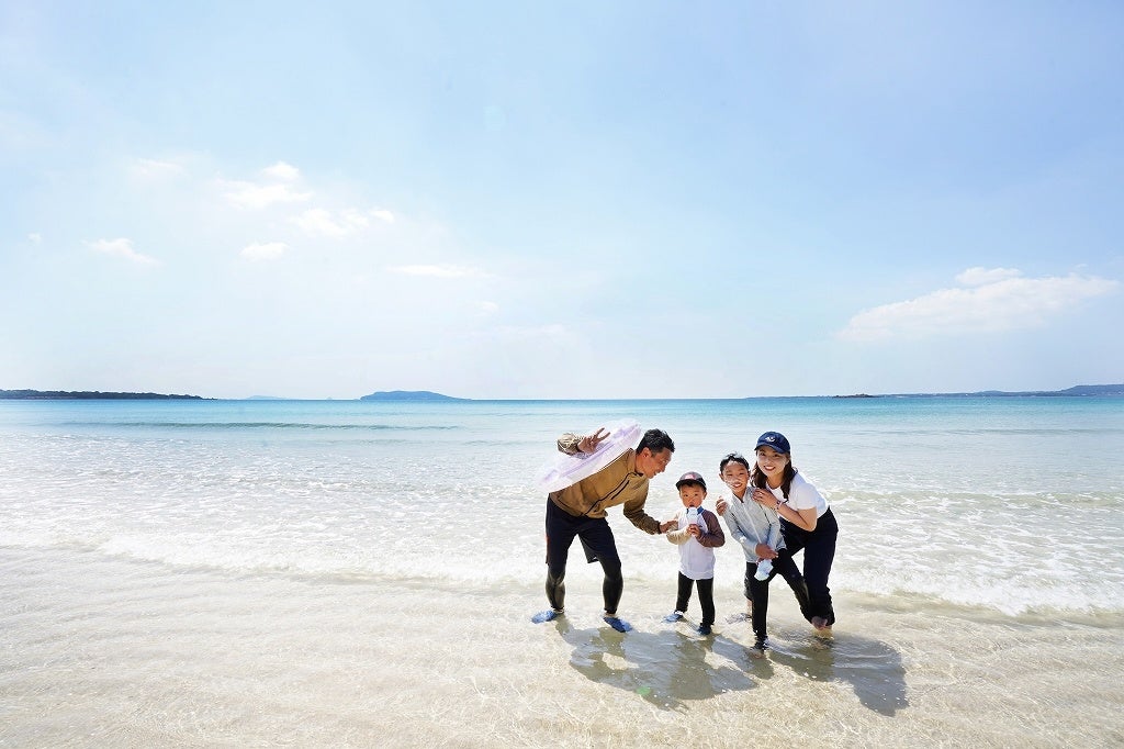 遠浅の砂浜で遊ぶ親子