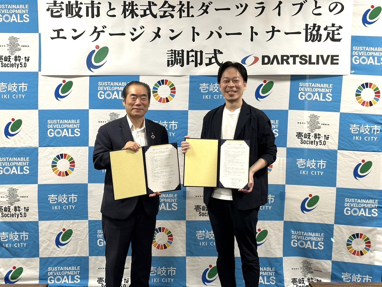 壱岐市役所にて締結調印式が実施。壱岐市・白川市長（左）とダーツライブ阿部社長（右）