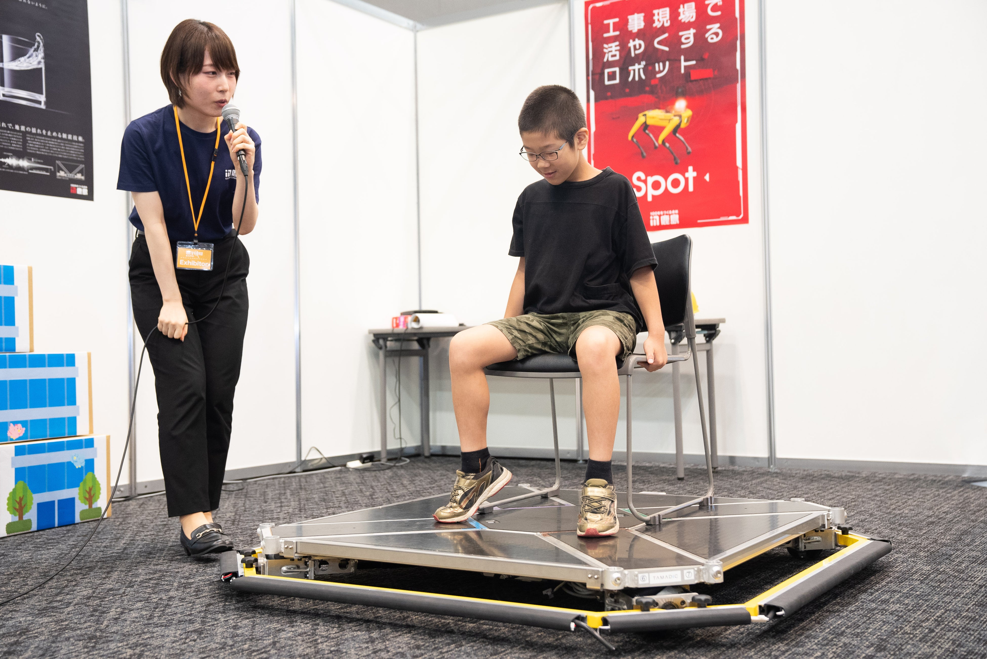 鹿島建設のブースより。地震時の建物の揺れを体験する子どもたち
