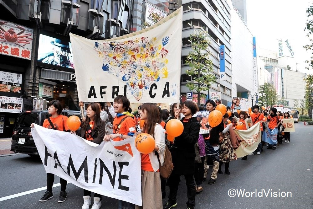 「飢餓をゼロにしよう」と呼びかけながら歩く大学生（2011年に開催したイベントより）