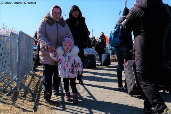 ウクライナと国境を接するポーランドのメディカにたどり着いた家族。ボランティアからの支援で衣類、毛布、温かい食べ物や飲み物、衛生用品などの必要な物資が配布されている。(ポーランド、2022年3月11日撮影) © UNICEF_UN0607443_Englis