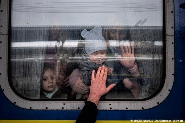 ハルキウから避難するための電車に乗り、残る家族に別れを告げる親子。(ウクライナ、2022年4月20日撮影)© UNICEF_UN0637170_Gilbertson VII Photo