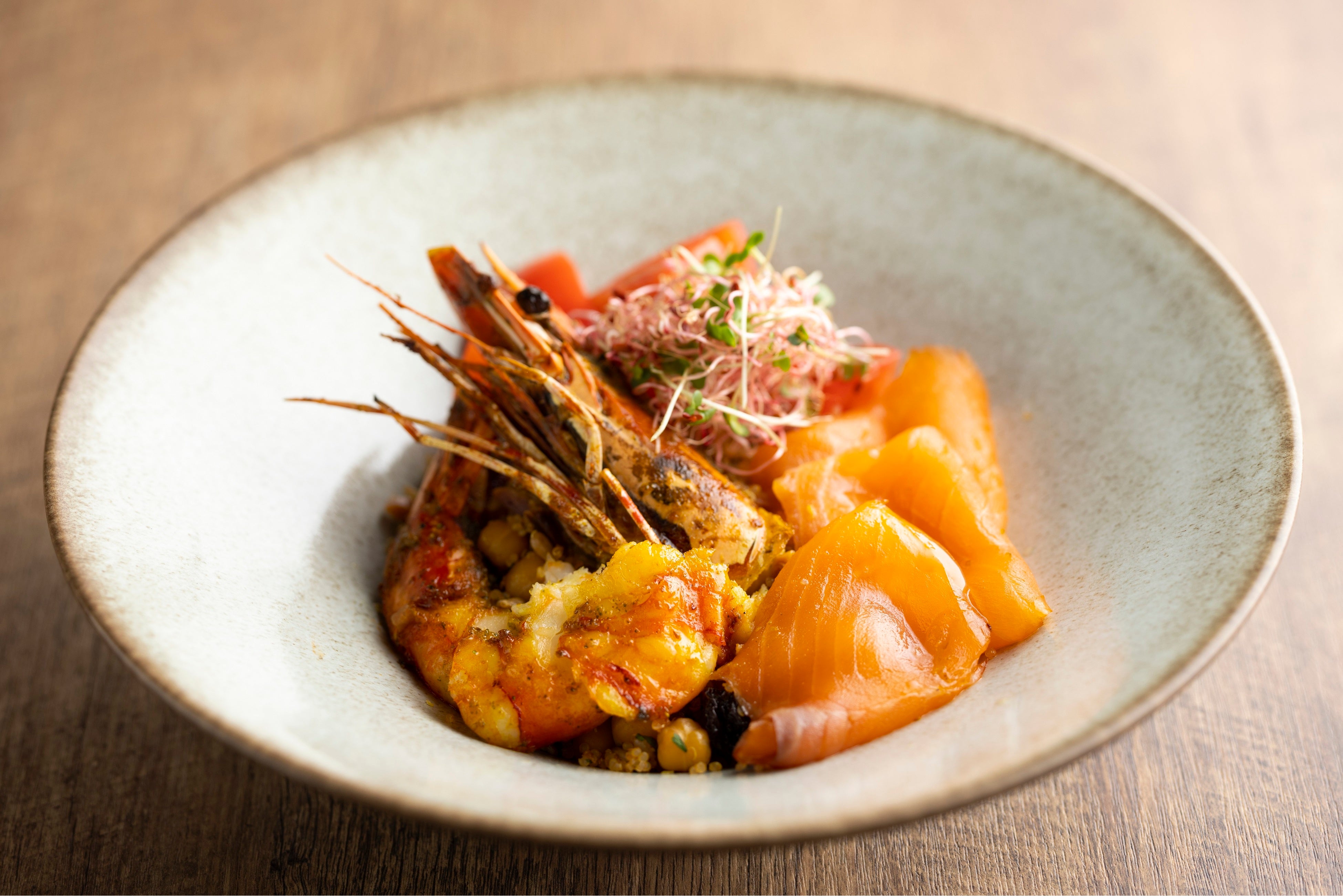 「シーフードボウル」 スーパーフードの「キヌア」をベースに、 大ぶりでぷりぷりなブラックタイガーとスモークサーモンを組み合わせました。海老とサーモンは高い抗酸化作用をもつ「アスタキサンチン」を多く含んでいるため、エイジングを気にかける方におすすめです。