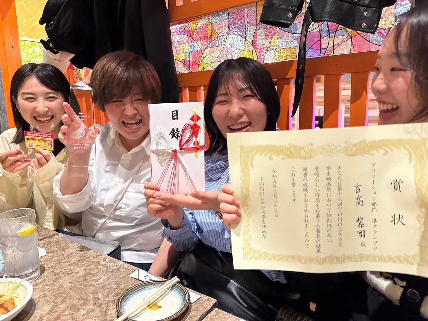 賞状を手に笑顔の学生