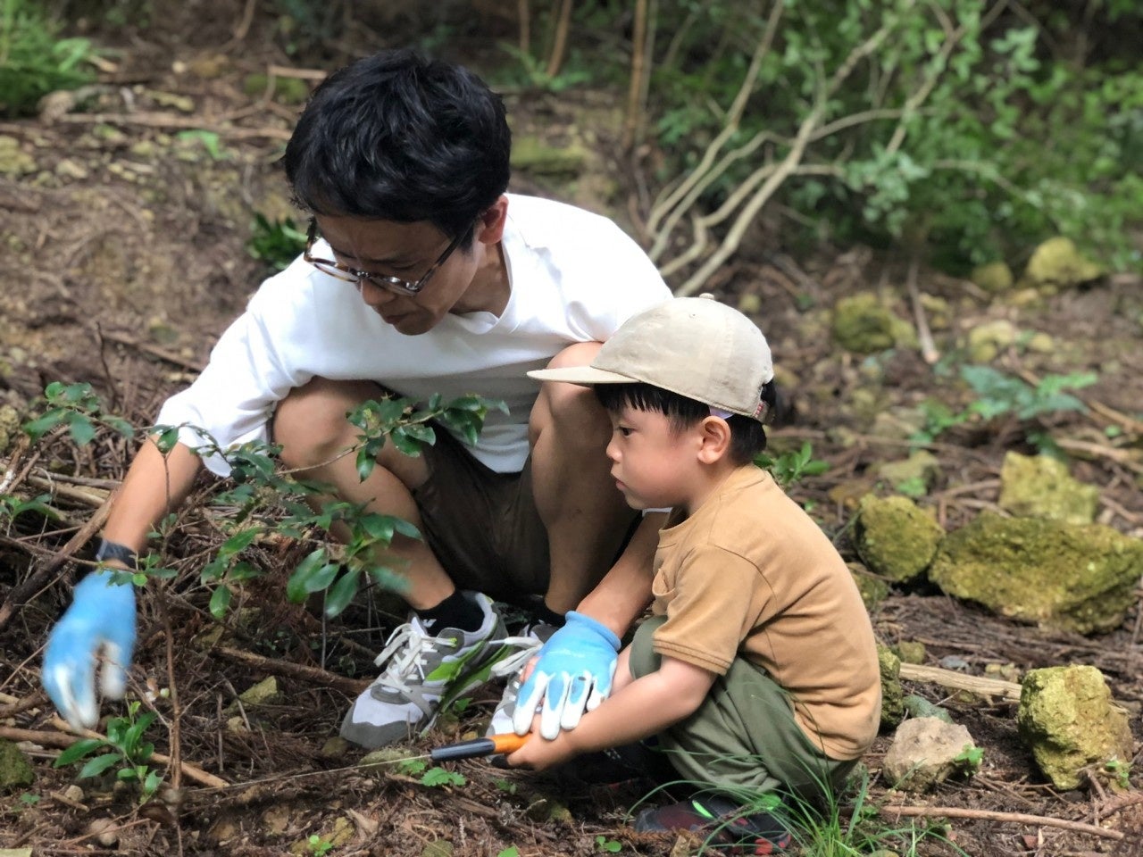 子どもと一緒に石拾いをする「女と男」市川