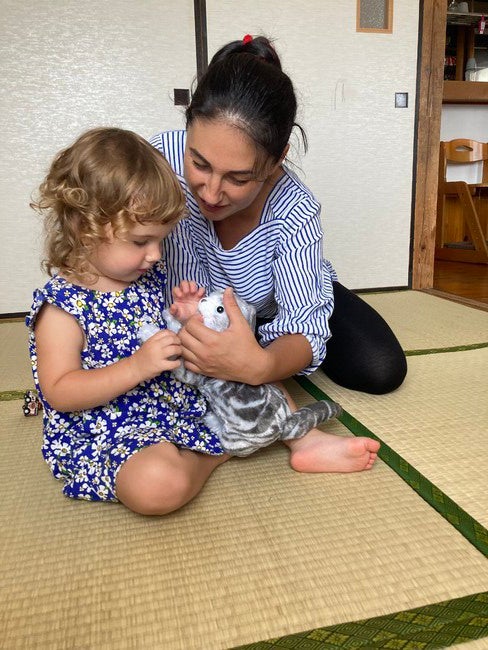 写真①お母さんと一緒にねこちゃんを可愛がる様子。