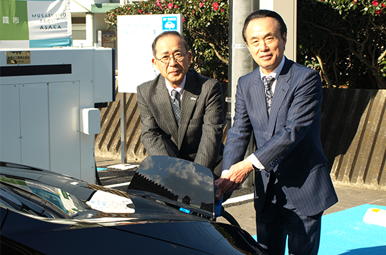 EVに充電する富岡市長(右)と鈴木社長(左)