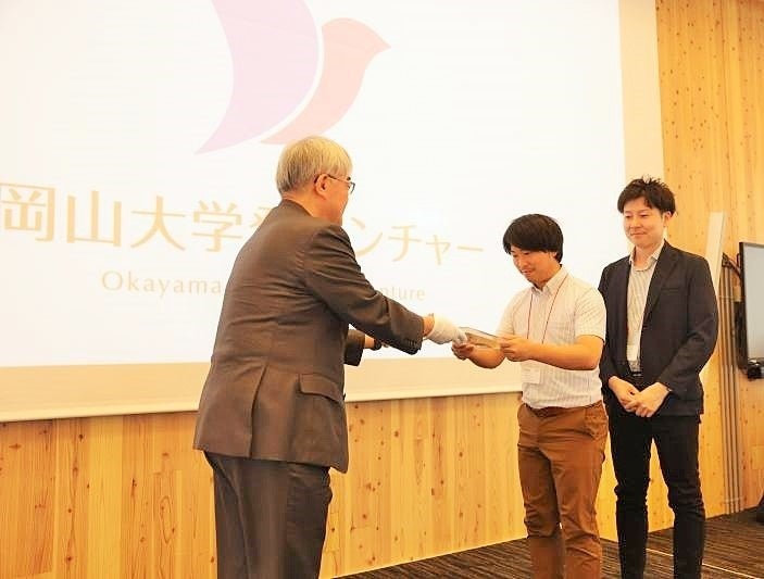 認定盾を授与される代表者（右）