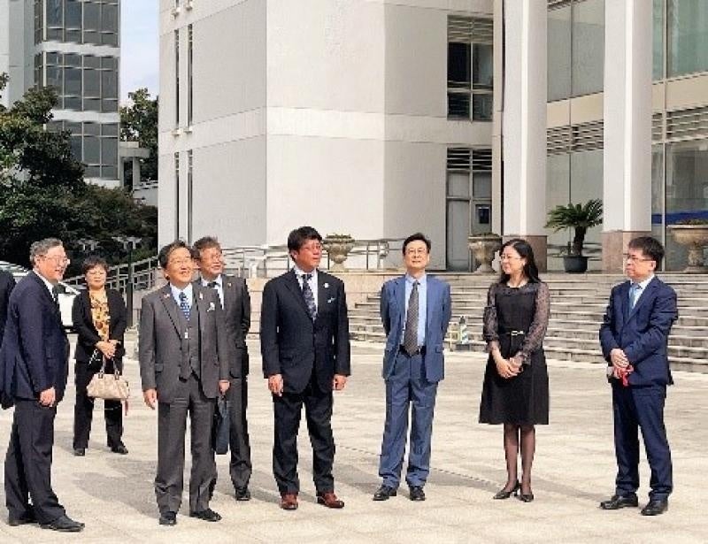 成党委員会書記（左）から学内の案内を受ける那須学長（左から3人目）