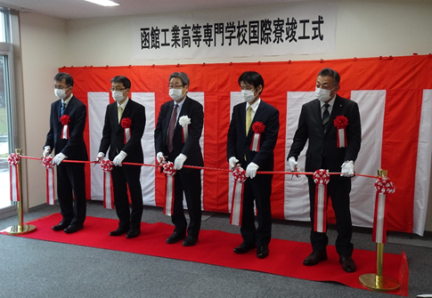 竣工式でのテープカット （左から，北海道渡島総合振興局 石丸副局長，文部科学省 笠原技術参事官， 伹野校長，高専機構 坪田理事，函館市 柏企画部長）