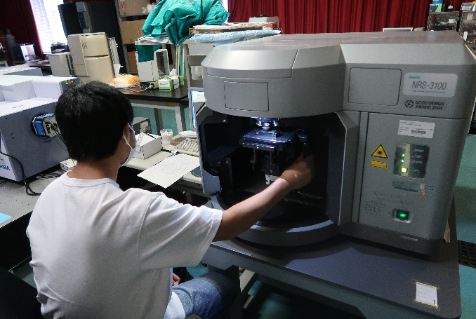 レーザーラマン分光光度計を操作する学生