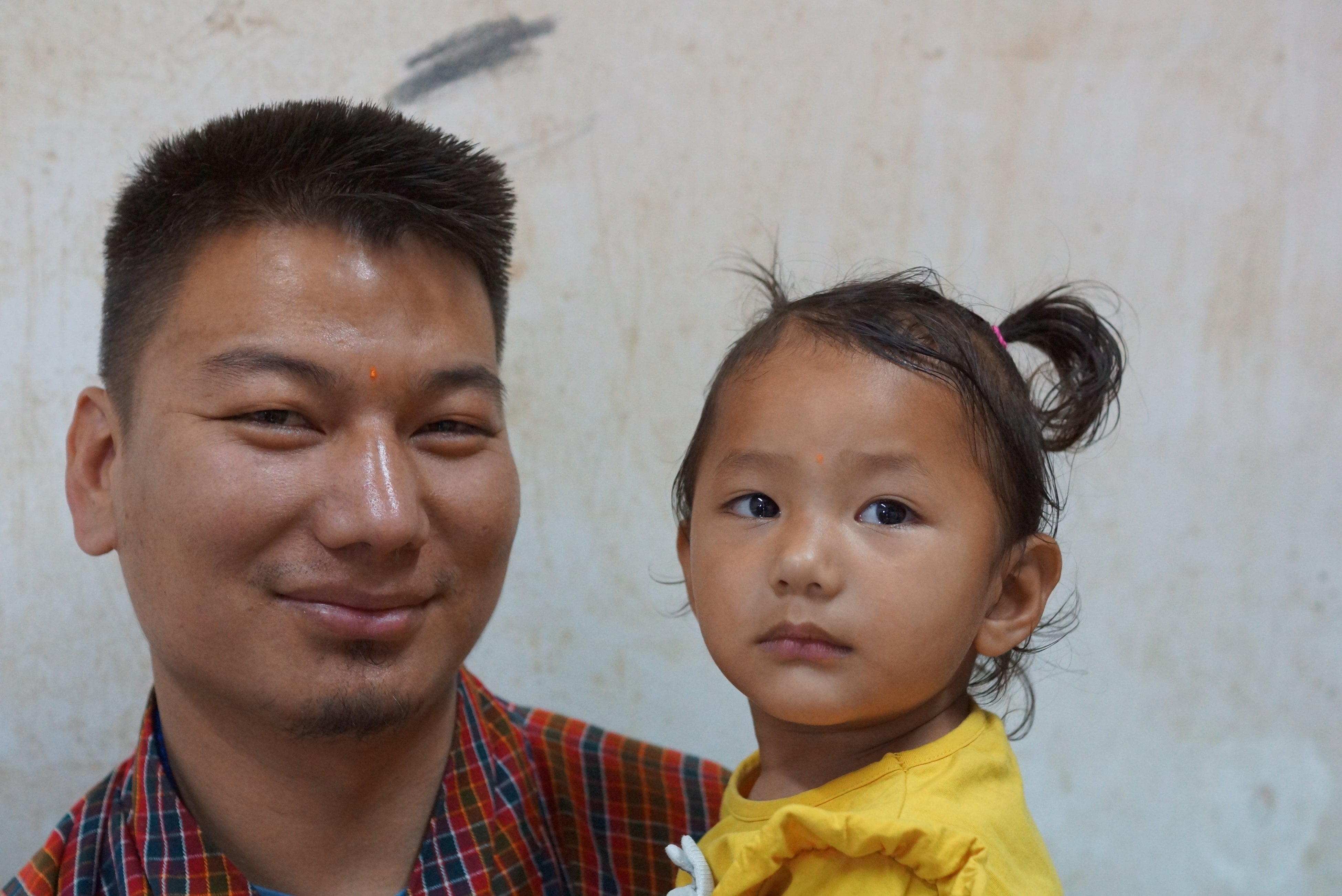 ワクチン接種を終えたブータンの子どもと父親